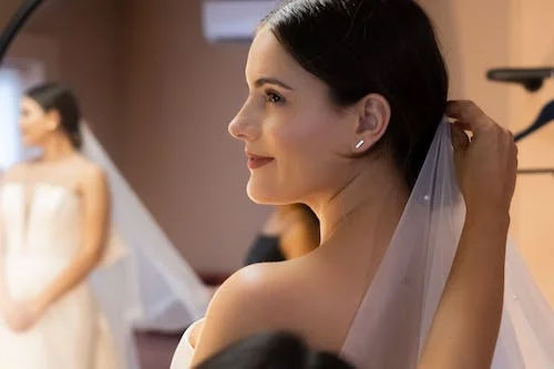 Free A Person Putting a Veil on a Bride Stock Photo